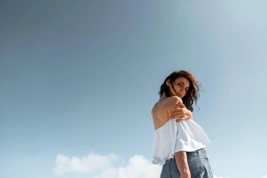 A woman in a flowy off-shoulder top