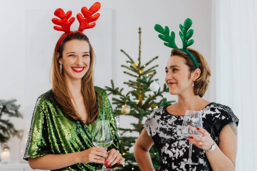 Frauen, die für eine Weihnachtsfeier Rentiergeweih-Stirnbänder tragen