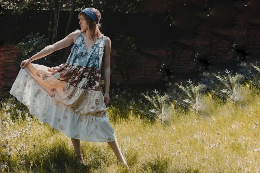 A woman wearing a long bohemian dress in a garden