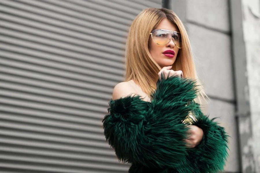 Woman in green fur off-shoulder top