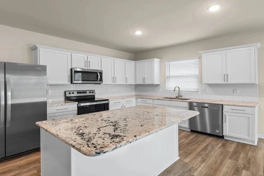 A smart fridge inside a white kitchen