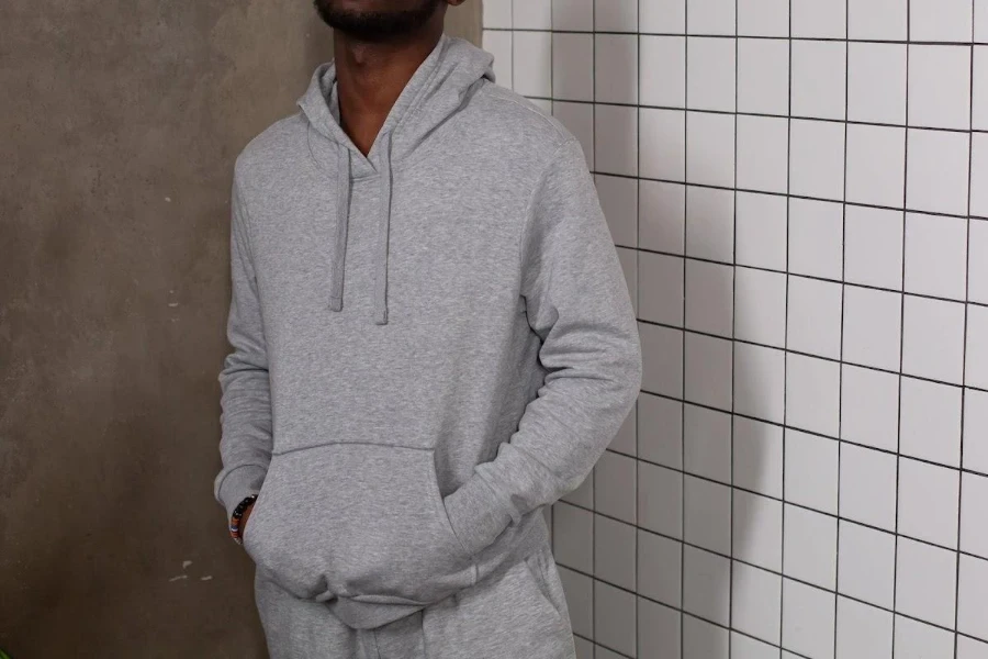 Man wearing a gray sweatshirt with matching pants