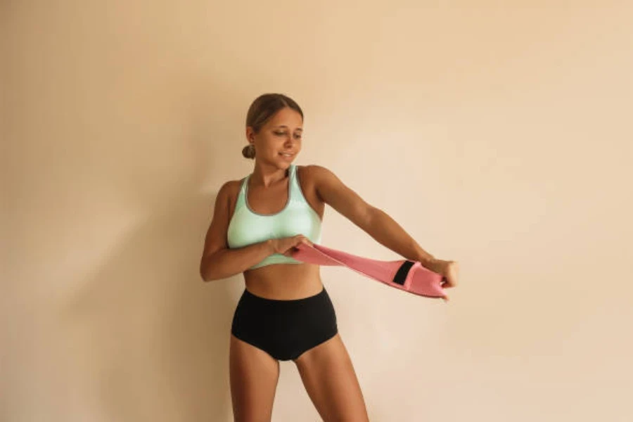 Femme tirant une bande de puissance en position debout