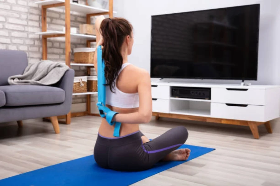 Woman stretching with variable resistance band at home