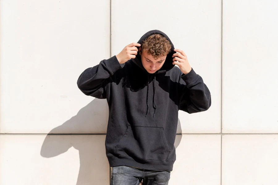 young man in black hoodie