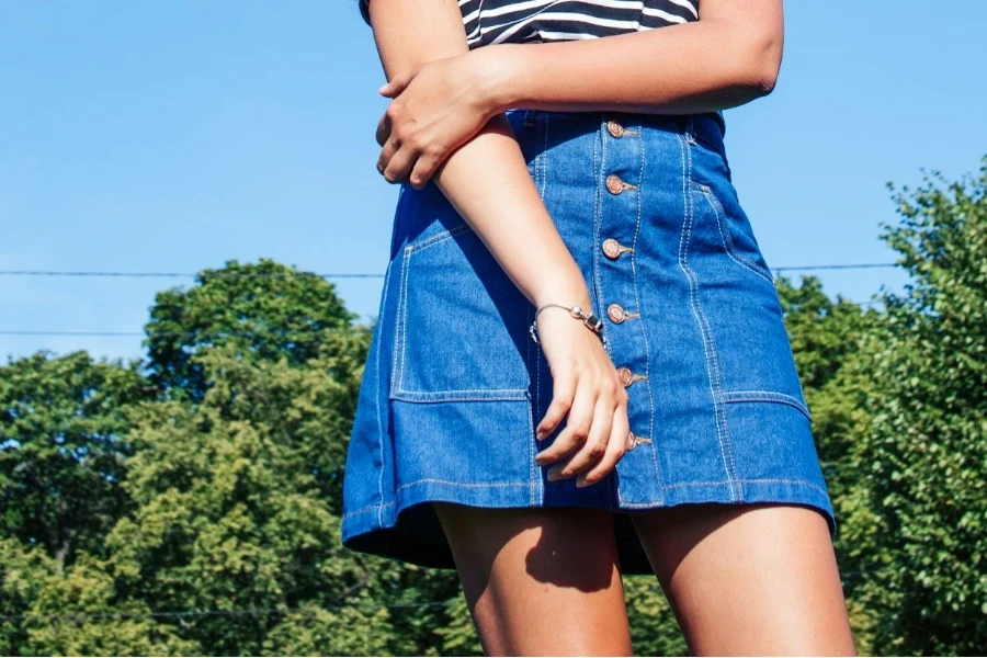 young woman in denim column kick skirt