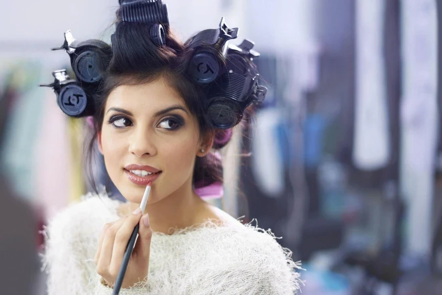 Young woman wearing magnetic hair rollers