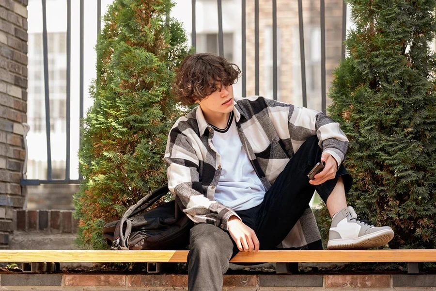 teen sitting on a bench