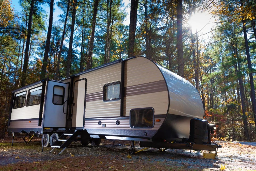 a photo of a travel trailer in the forest