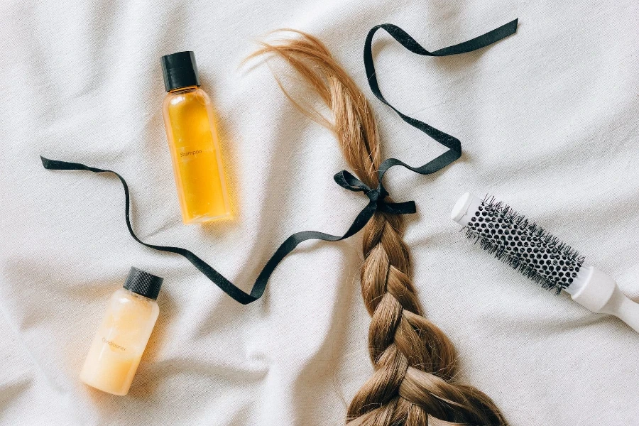 French braid laying on a bed tied up with a bow