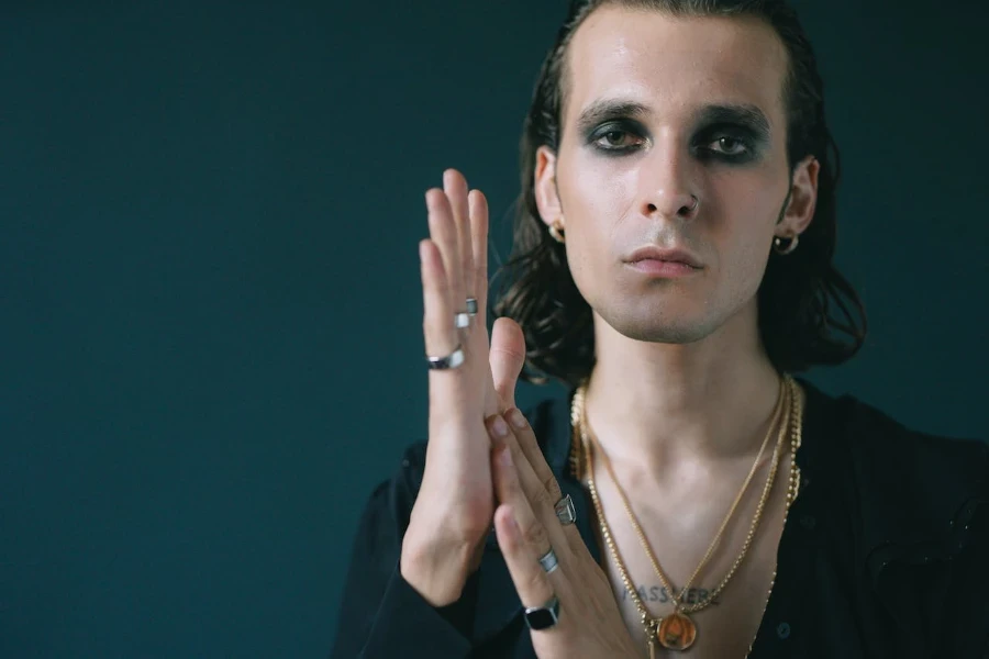 Man with shoulder length hair with smokey eyes