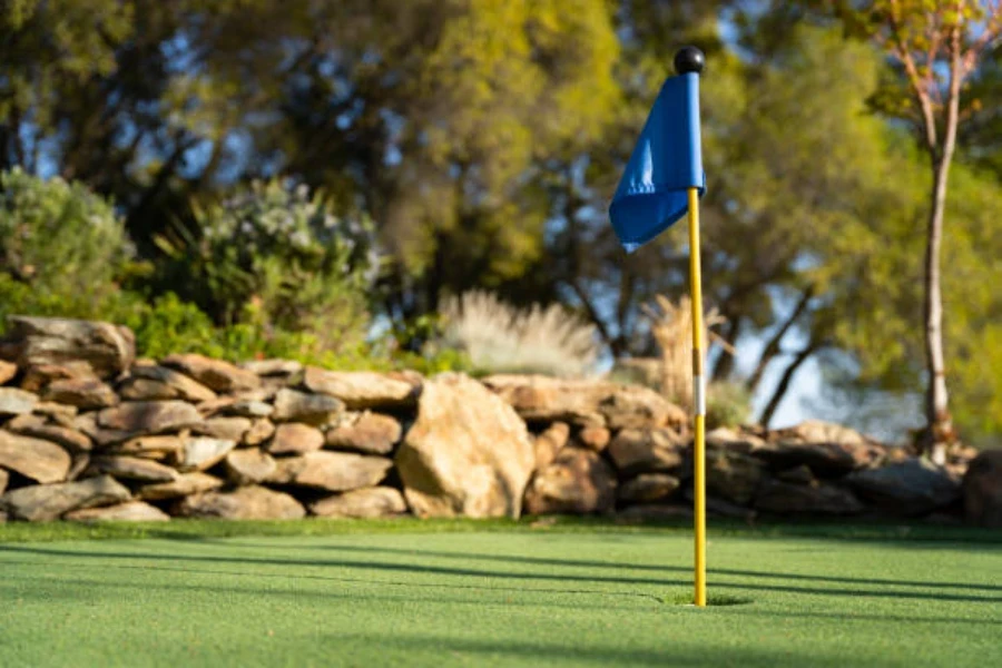 Putting green outdoors laid with artificial grass on a sunny day