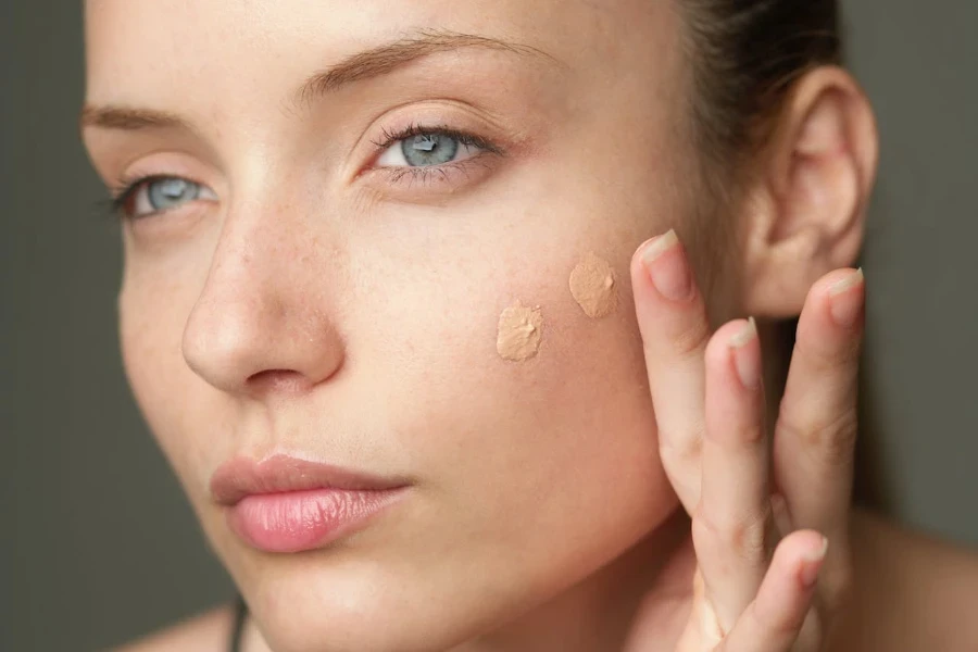 Woman applying foundation with their finger