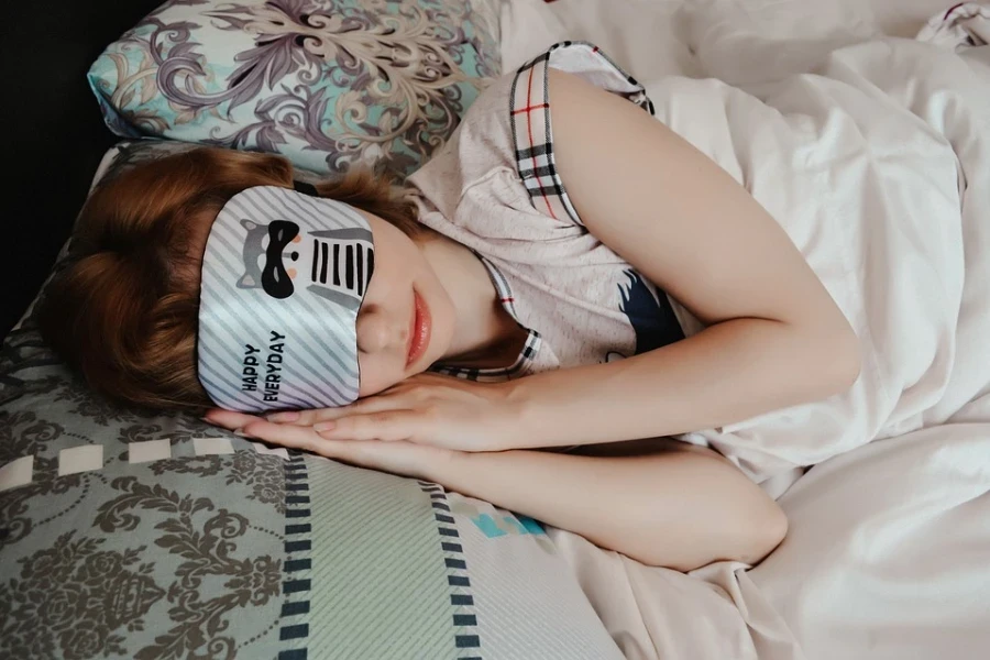 Wanita tidur dengan masker mata kain putih