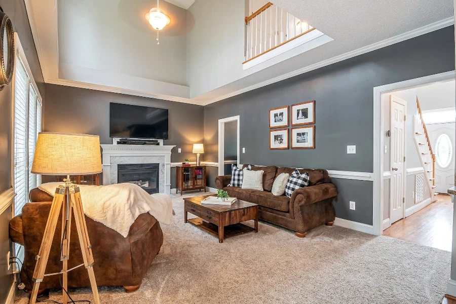 A tripod lamp in a living room