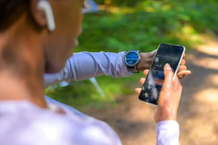 A woman monitoring her progress using a fitness tracker