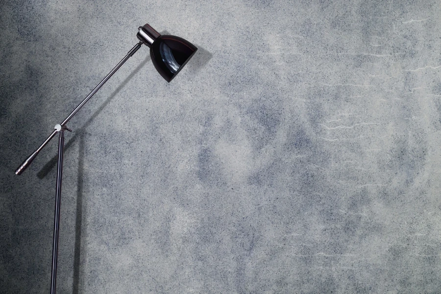 An industrial lamp next to a textured wall