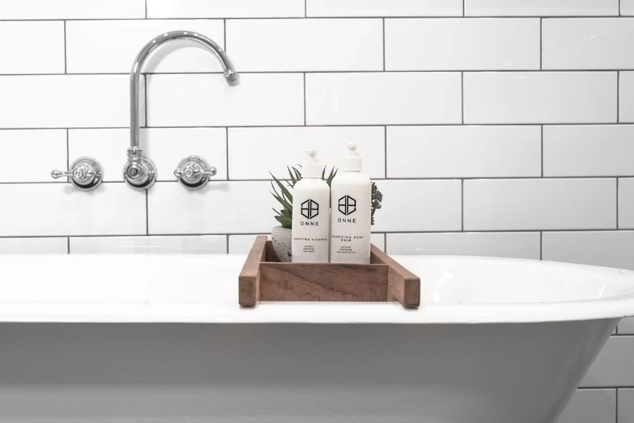 White freestanding tub with wooden bath tray