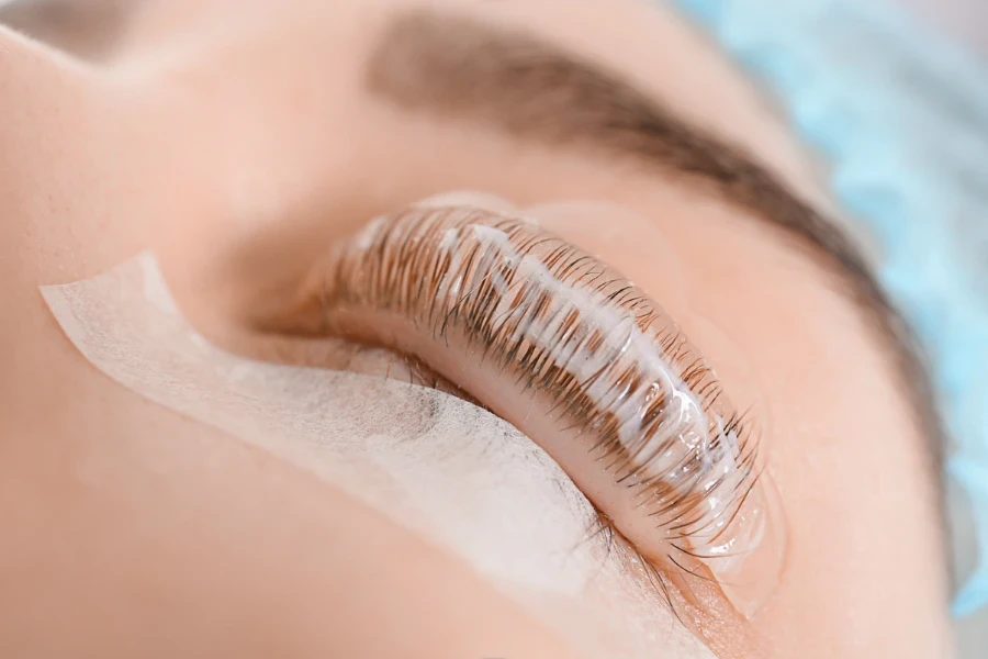 A lady with a gel pad and lash tape