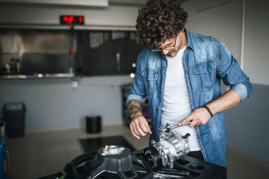 A man checking a car AC compressor