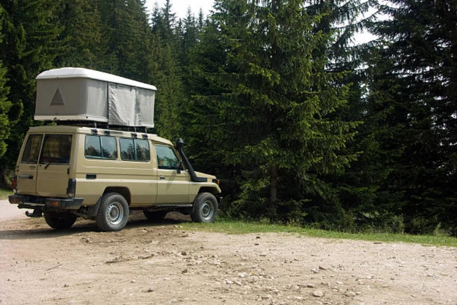 Hard shell rooftop tent expanded on top of vehicle