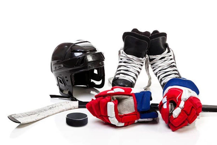 Ice hockey equipment sitting on plain white ice