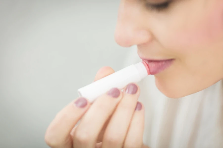 Lady using a hydrating lip balm