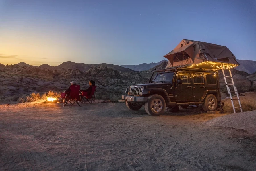 Rooftop tent with ladder and string lights hanging from it