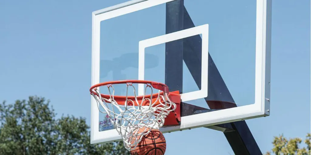 A basketball going into a basketball hoop