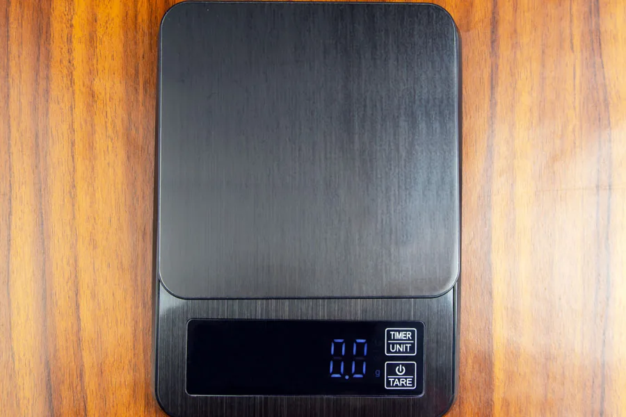 A black digital food scale on a tabletop