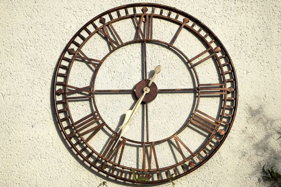 A brown metallic wall clock