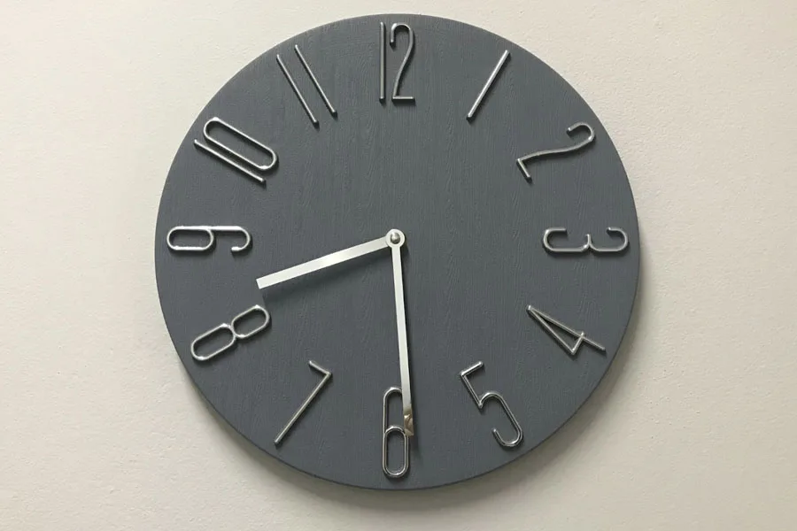 A gray minimalist and contemporary wall clock