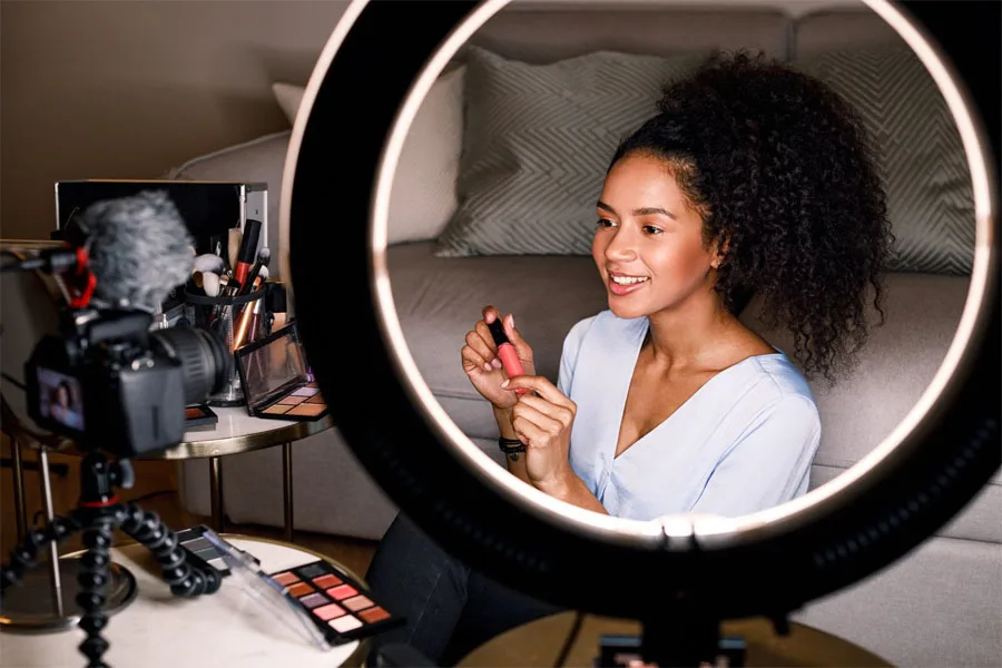 A woman using ring light to make a product demo