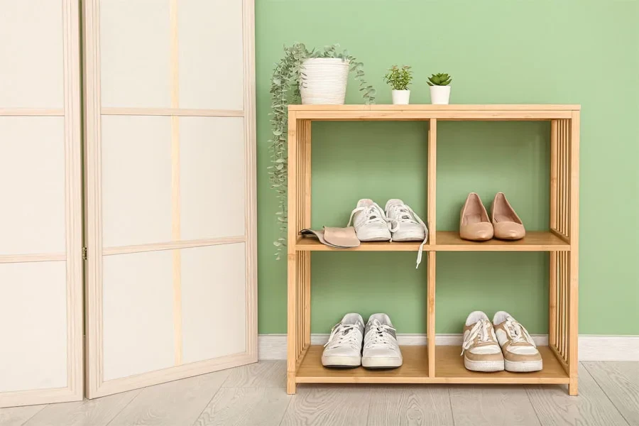 A wooden shoe rack with houseplants placed on it