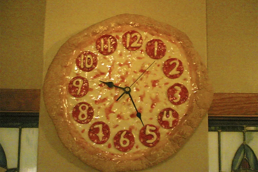 An unconventional novelty pizza wall clock