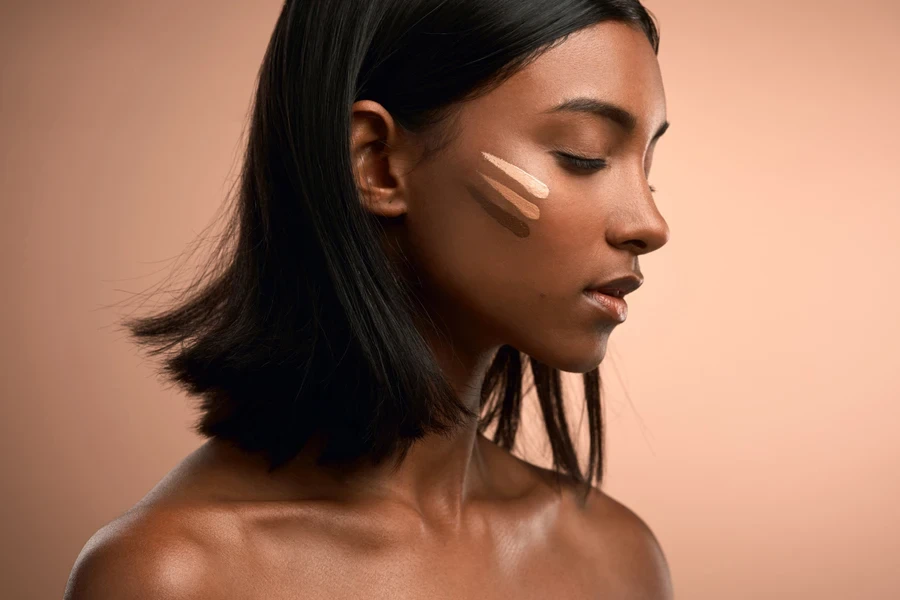 Dark-skinned person applying foundation