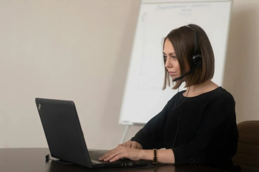 Female operator working with headphones with microphone