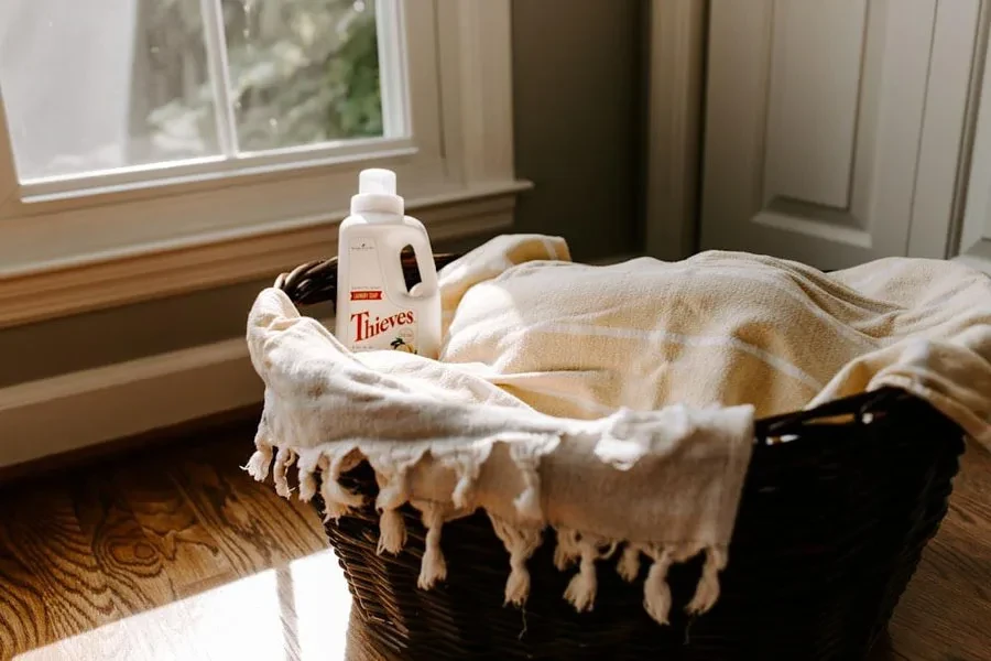 Laundry detergent inside dark brown wicker hamper