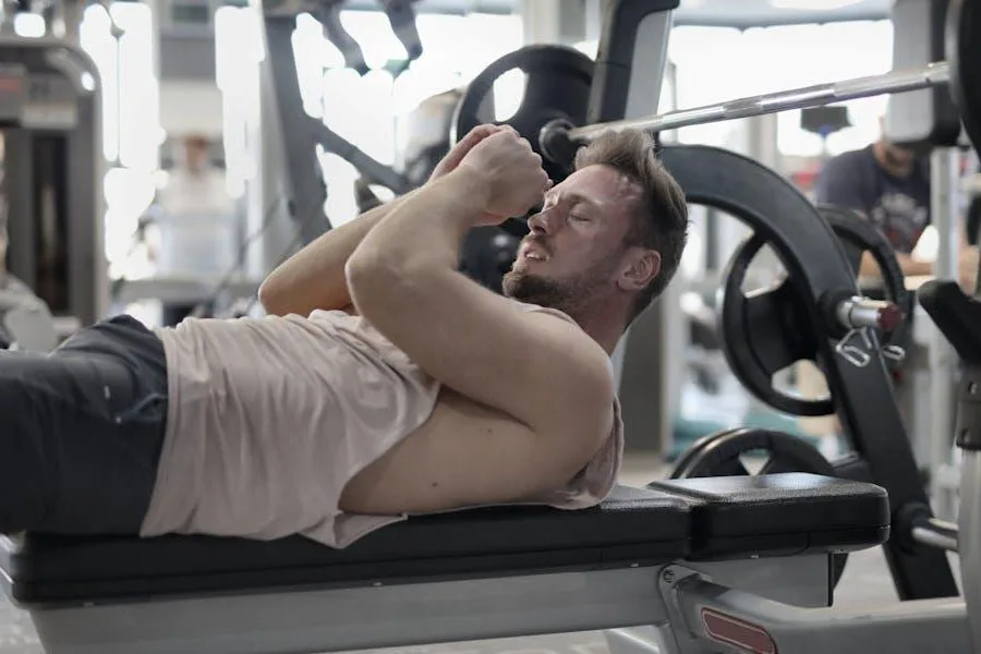 Man engaging in strength training on a weight bench