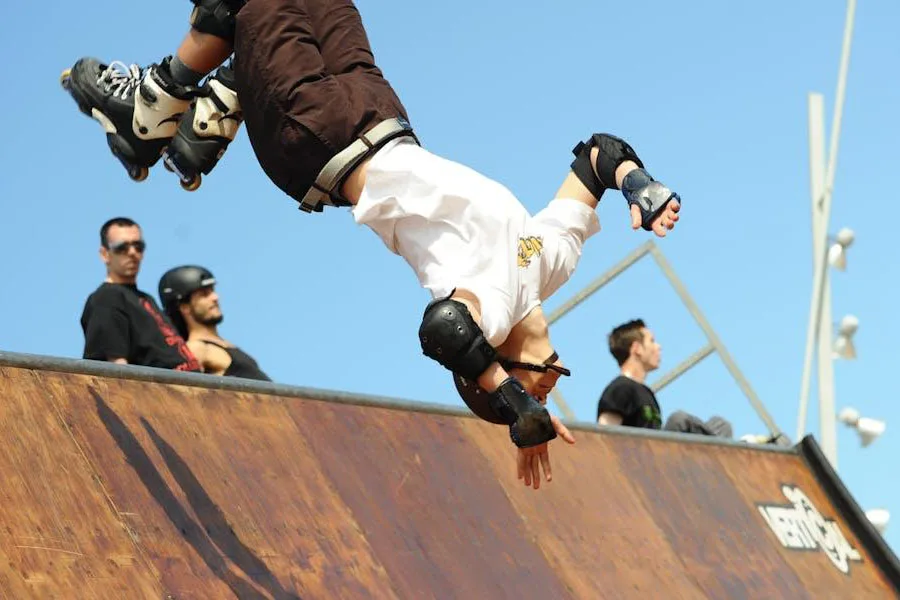 Man flipping in the air while using elbow pads