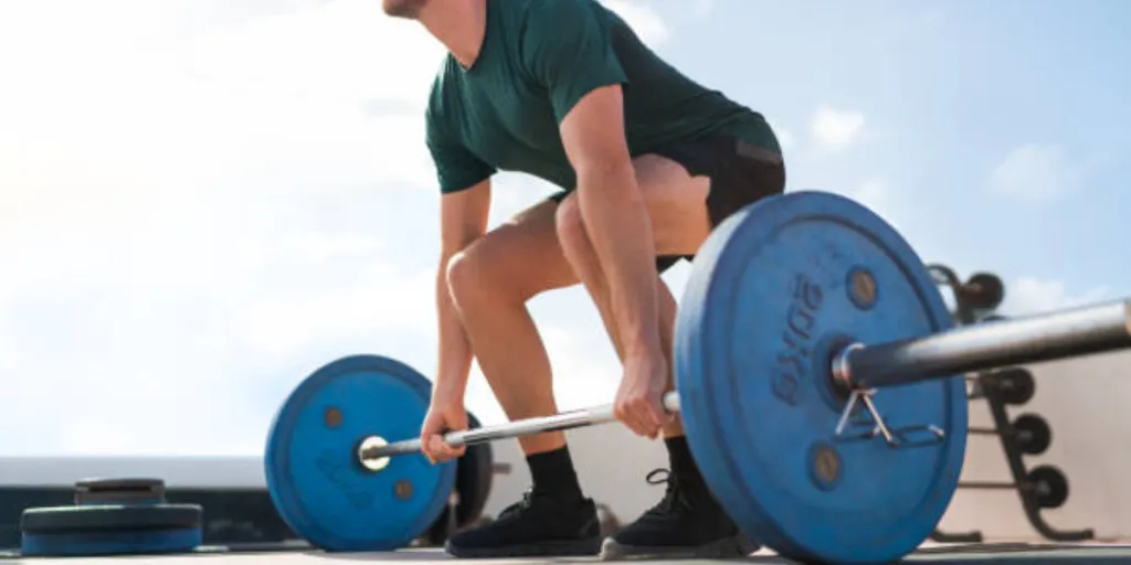 Man preparing to lift barbell with barbell collars attached