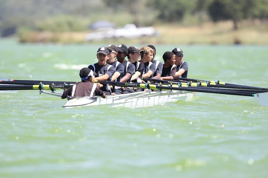 People engaged in competitive rowing