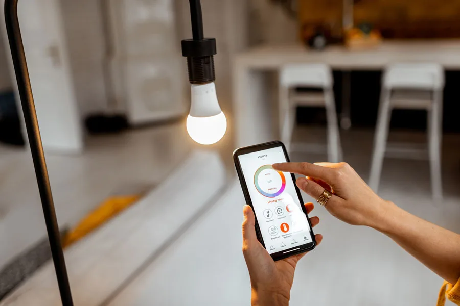 Person controlling light with smartphone