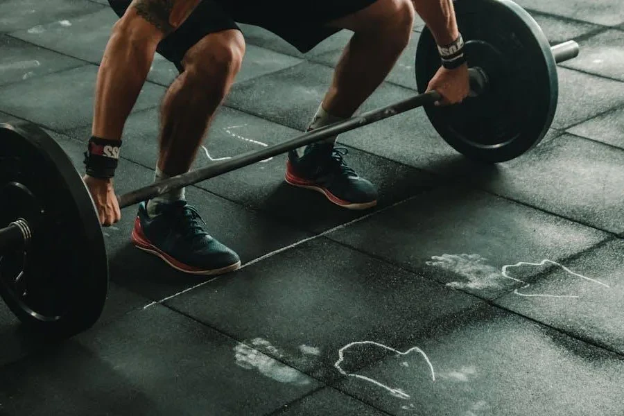 Person preparing to lift weights while wearing weightlifting shoes