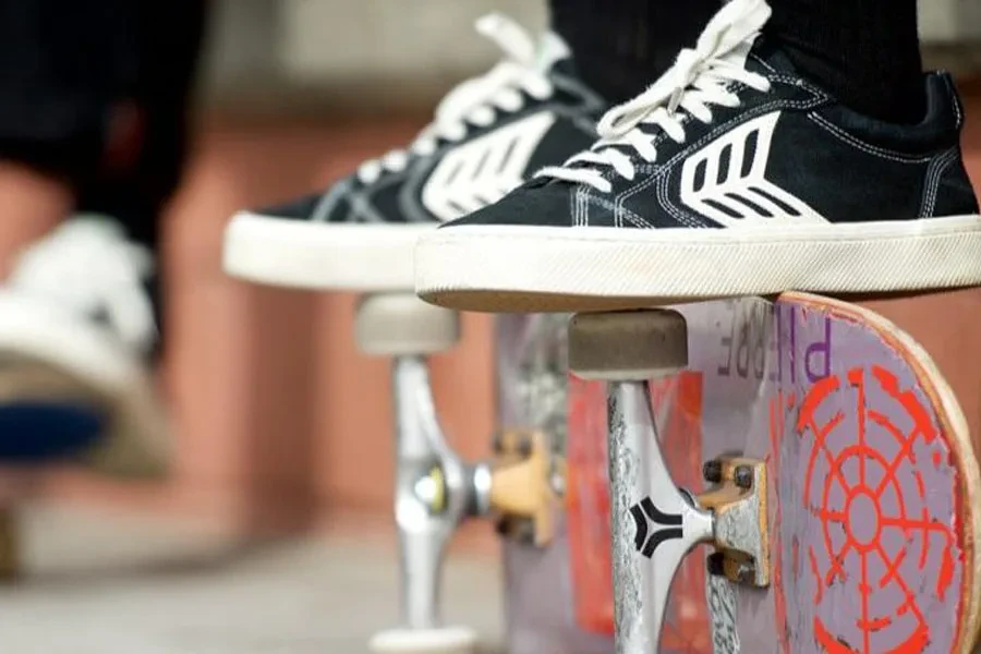 Person resting feet on a skateboard while rocking nice skate shoes