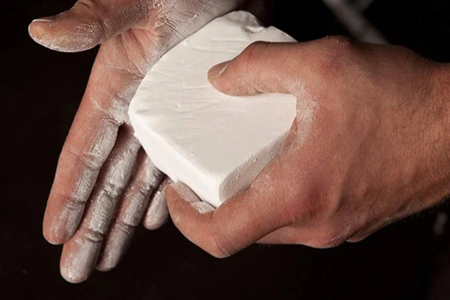 Person rubbing a block of chalk