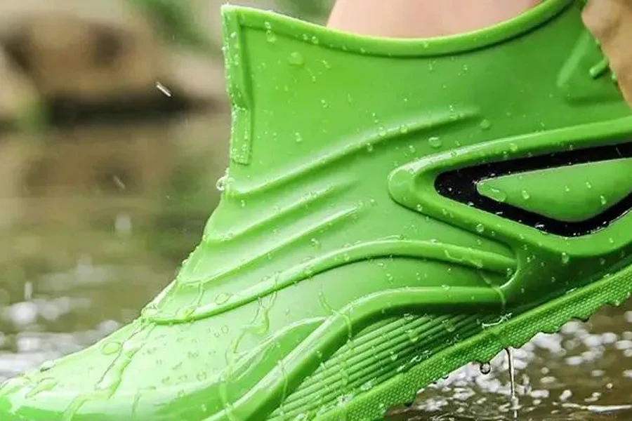 Person wearing a heavy-duty green water boot