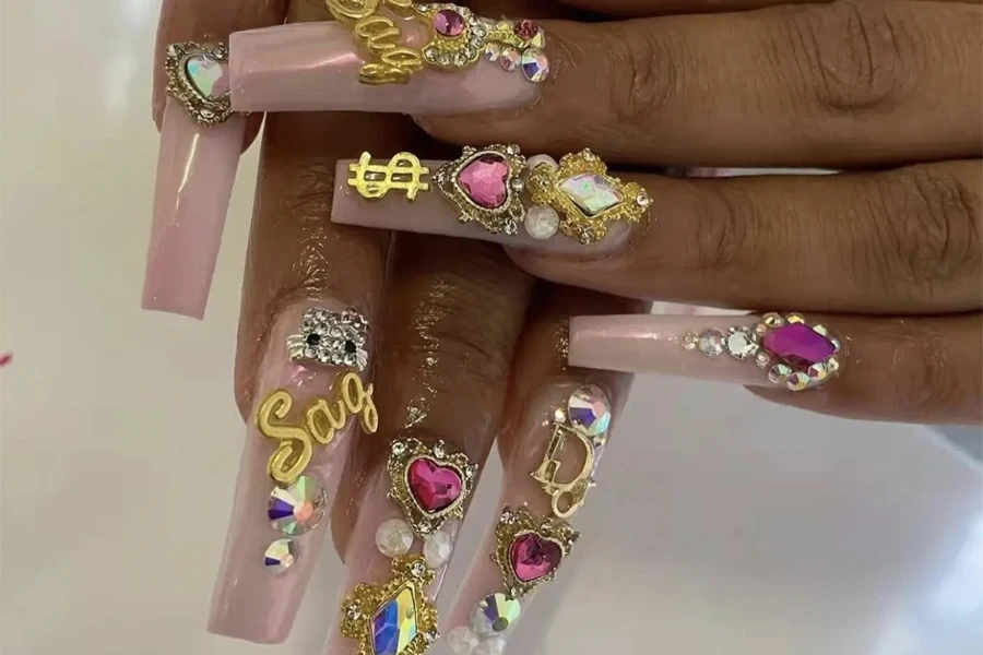 Pink fingernails with an array of shiny rhinestones