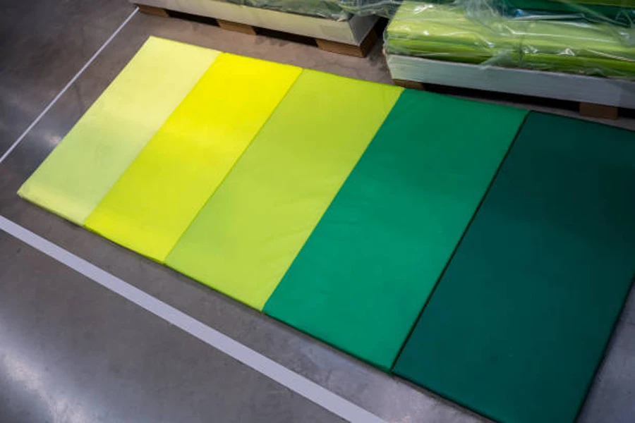 Row of gymnastics folding mats in different colors
