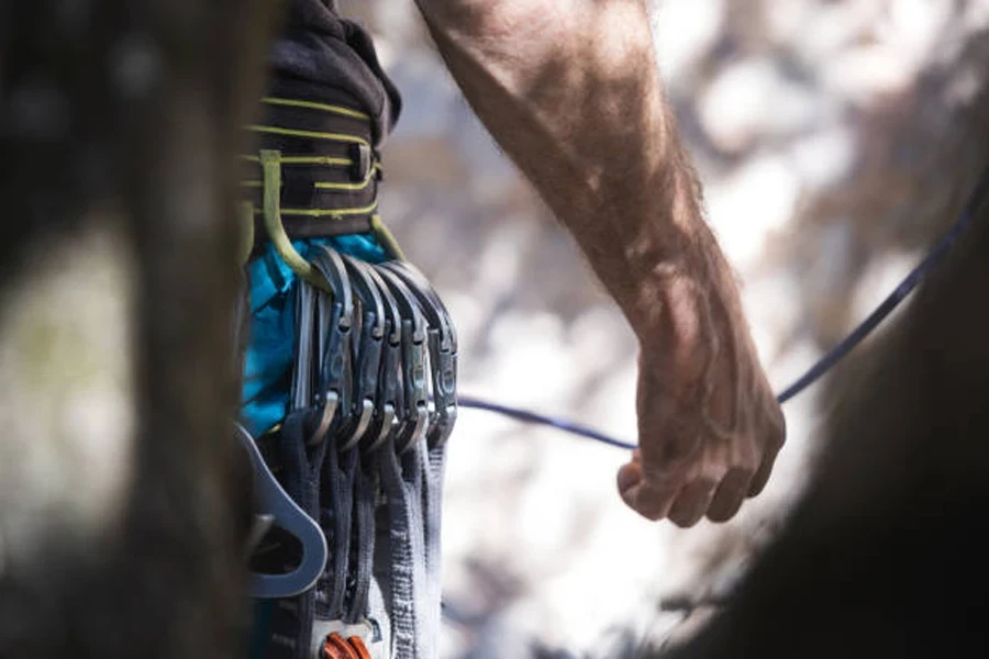 Row of non-locking carabiners attached to climber’s belt